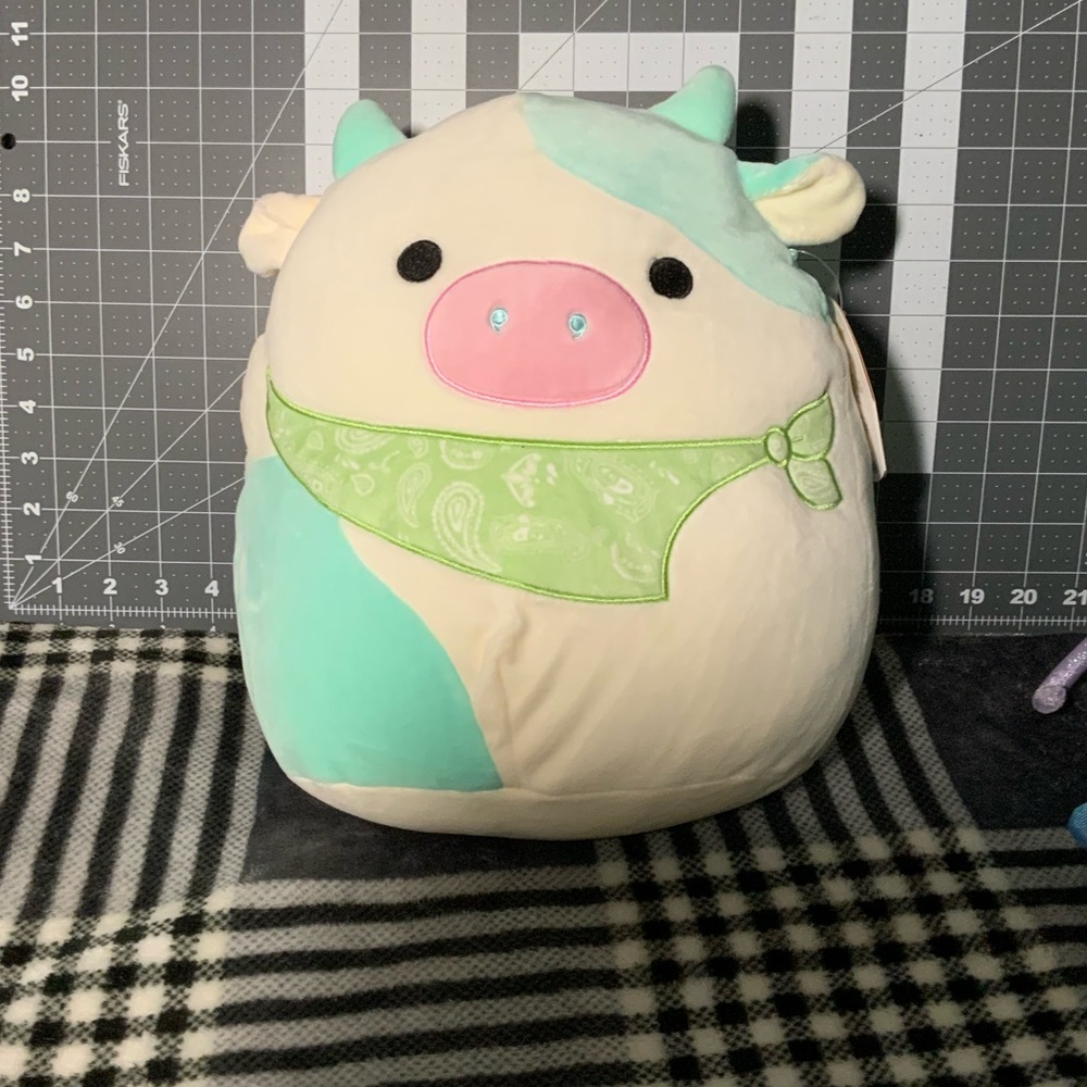 Squishmallow Belana the cow, with green bandana